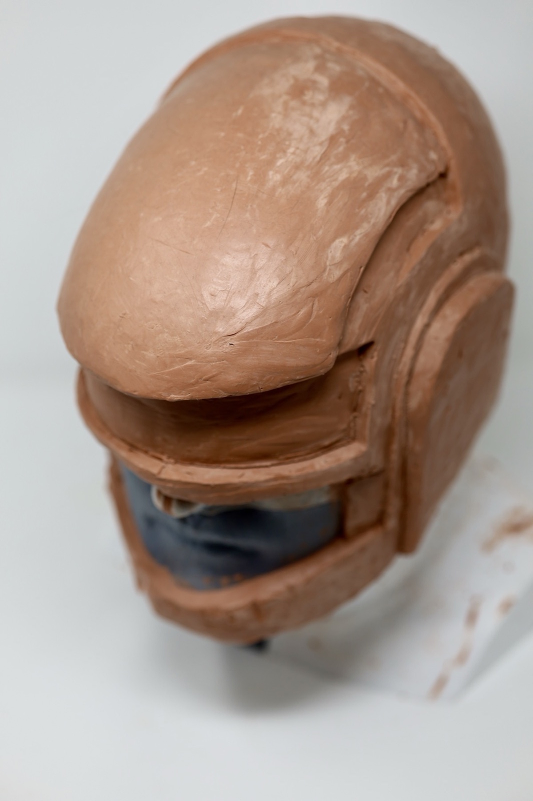 Three-quarter view of the rough clay Daft Punk helmet sculpt