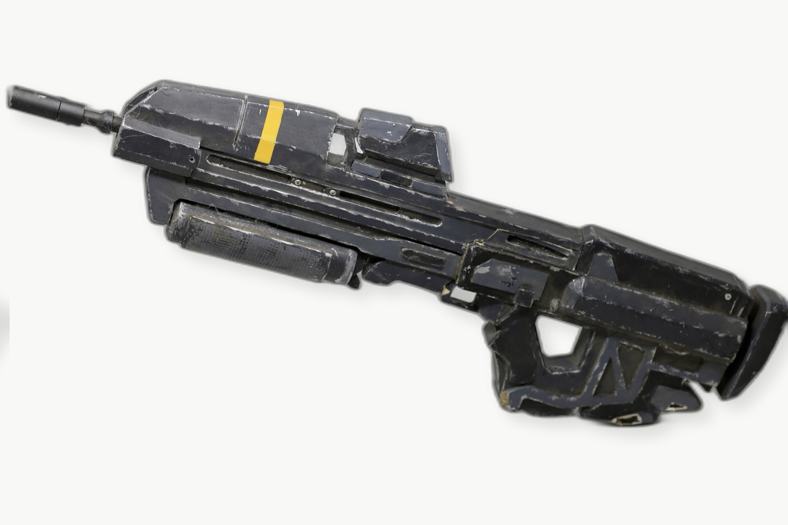Side profile of the weathered Dawn Under Heaven assault rifle prop on a clean white background