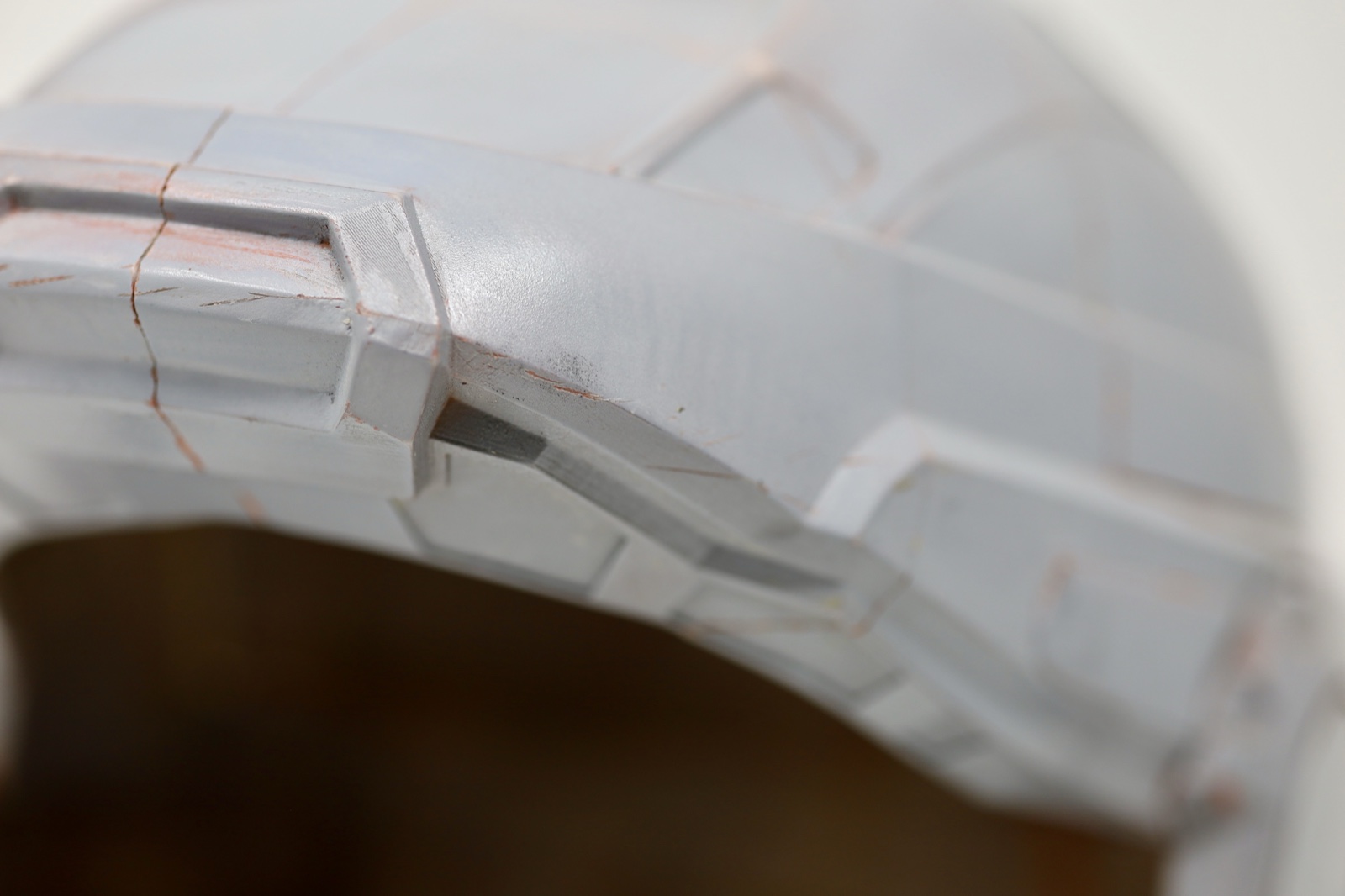 Close-up of the helmet brim and panel lines during surface finishing
